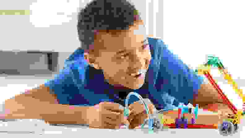 A boy playing with K'nex