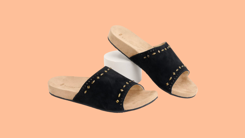 An image of a pair of cork-bed sandals with a wide black fabric strap.