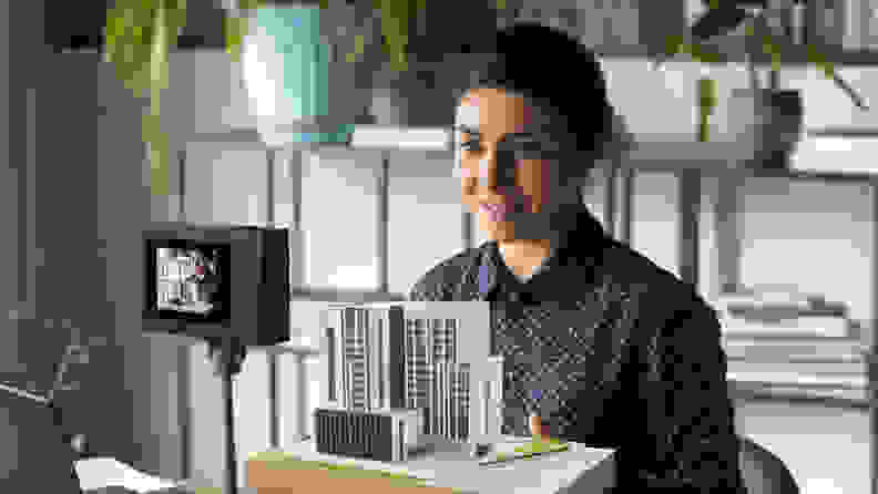 A person using the Acer SpatialLabs Eyes stereo camera to display an architectural model.