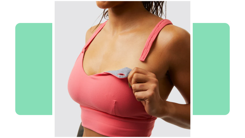 Person holding tab on the pink Born Primative Milk and Muscles Nursing Sports Bra.