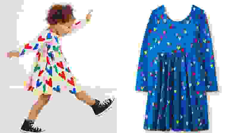Child in colorful heart-printed dress in white and blue.