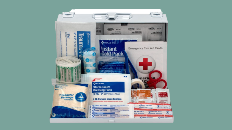 Product shot of a first aid kit with assorted items inside.