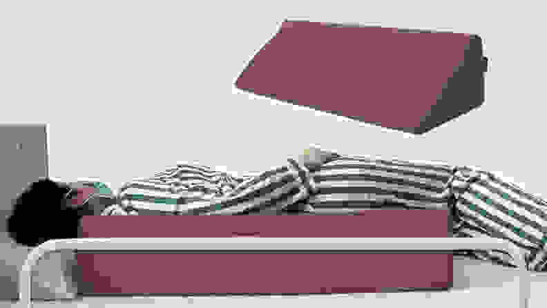 Person lying in bed while using the foam Aossa wedge and the  Aossa wedge by itself.