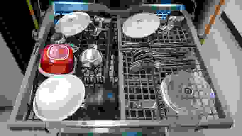 Assorted dishes and silverware sitting on third rack of LG LDTH7972S dishwasher.