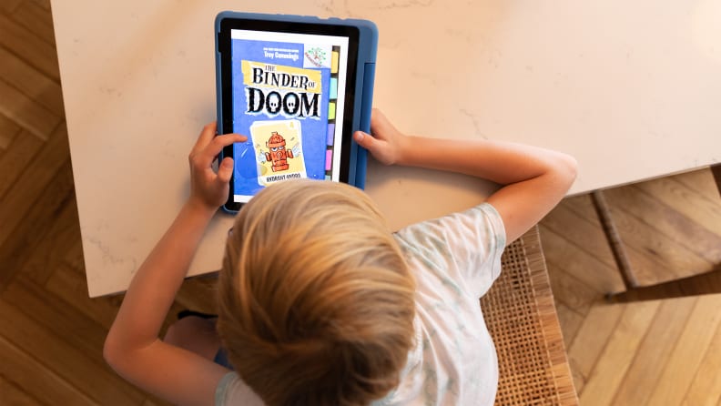 A child reading Binder of Doom on Amazon Fire 10