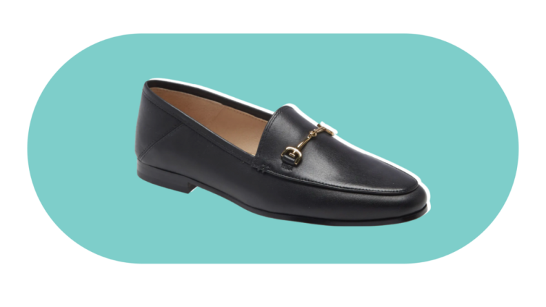 A black loafer with gold horse-bit details on the upper.