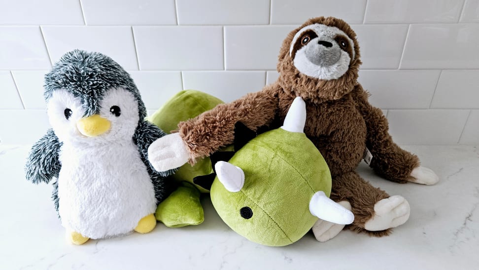 Three weighted stuffed toy animals assembled together on marble countertop.