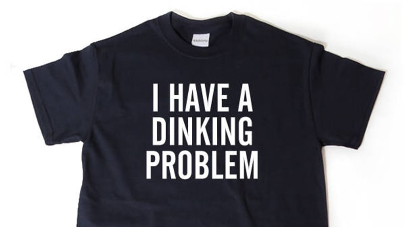 Black shirt that reads "i have a dinking problem" in white text