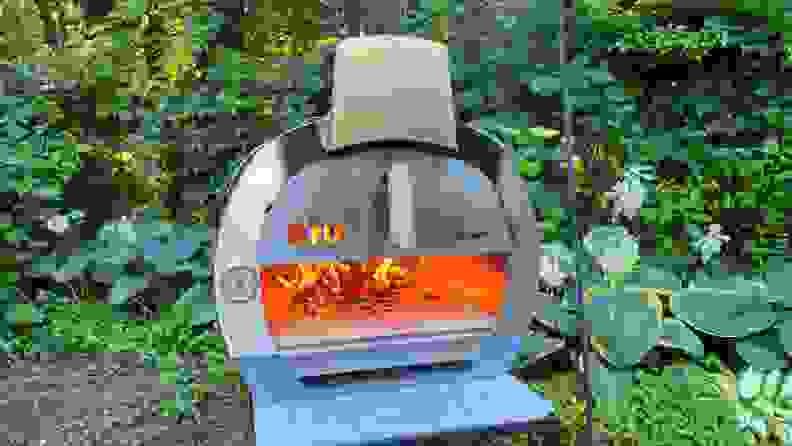 The Cru 32 Pizza oven with a roaring fire inside.