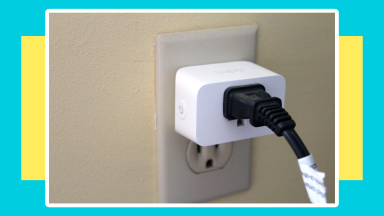 Black utility plug connected to the Tapo Smart Plug Mini in wall.