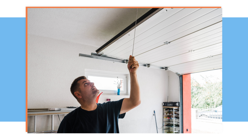 Person using string to pull emergency latch on garage door.