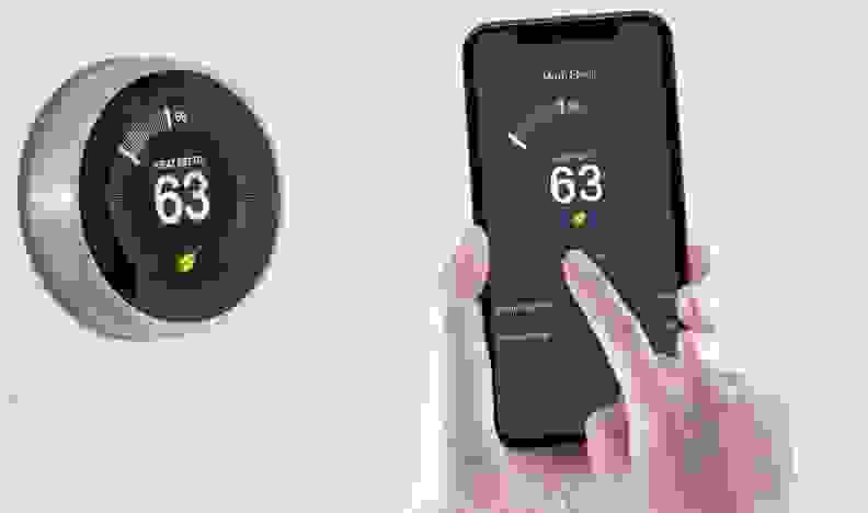 A smart thermostat being used with a smartphone.