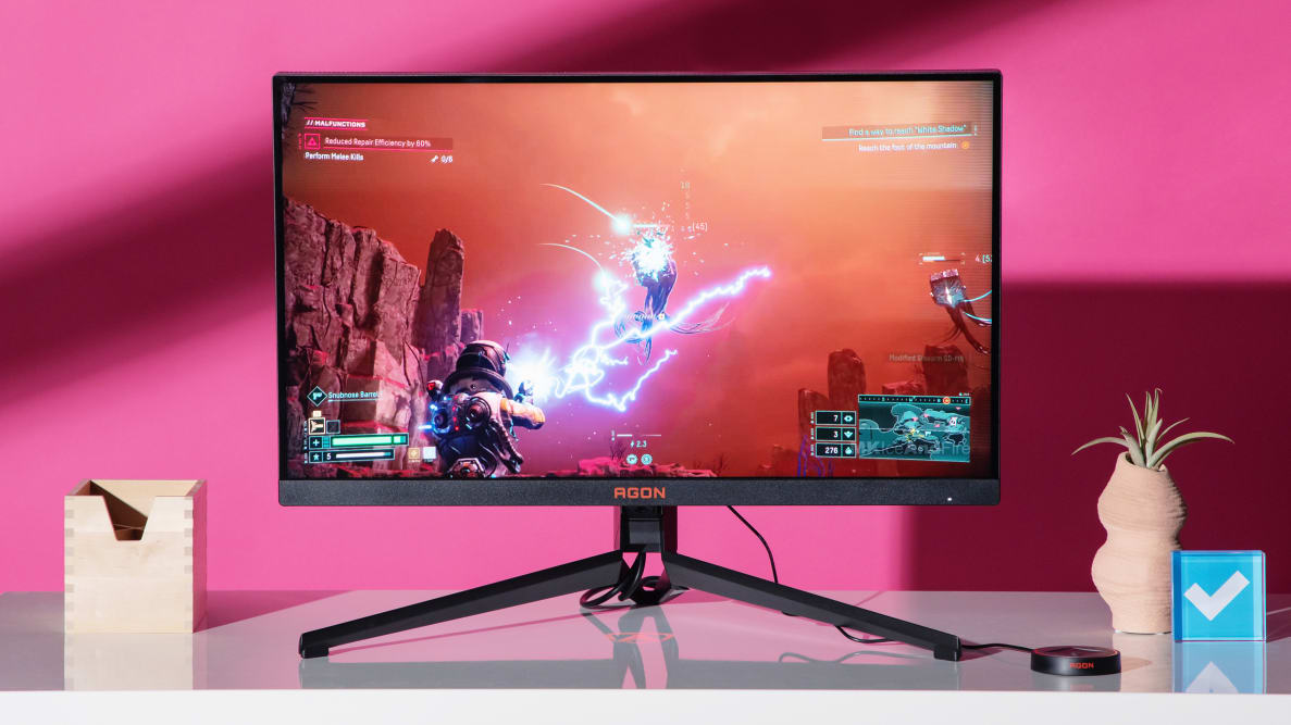 The AGON PRO AG274QZM on a white desktop with a video game on the screen.