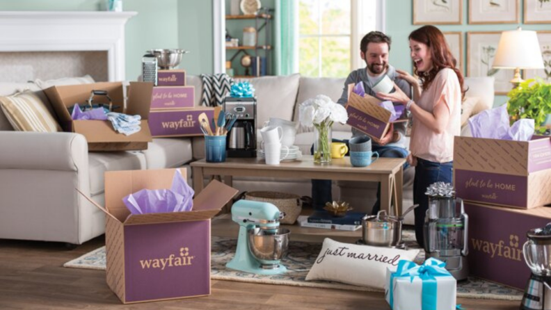 couple embracing among wayfair boxes