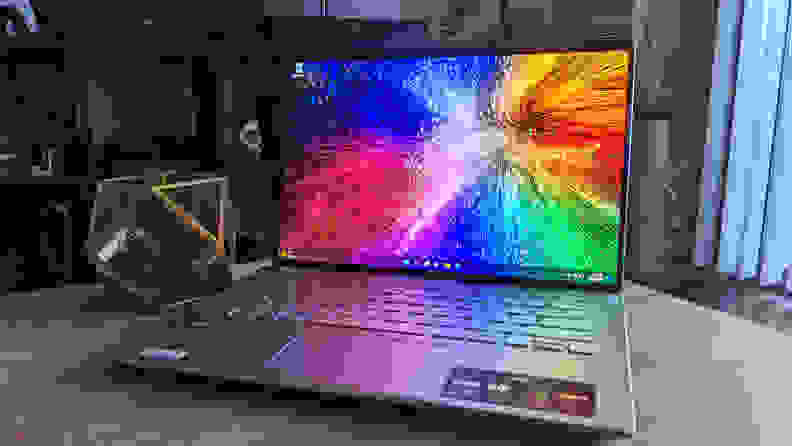 An open and powered on laptop showing a colorful screen