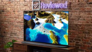 The 65-inch Sony A95K QD-OLED TV displaying colorful 4K/HDR content in a living room setting