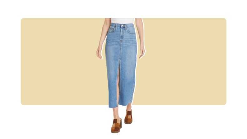 A model wearing a blue denim maxi skirt with patchwork clogs.