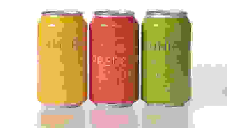Three colorful cans of spiced soda.