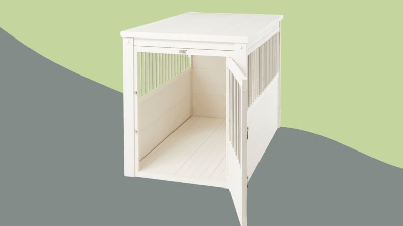 A white wooden dog crate that looks like a piece of furniture on a green and gray background