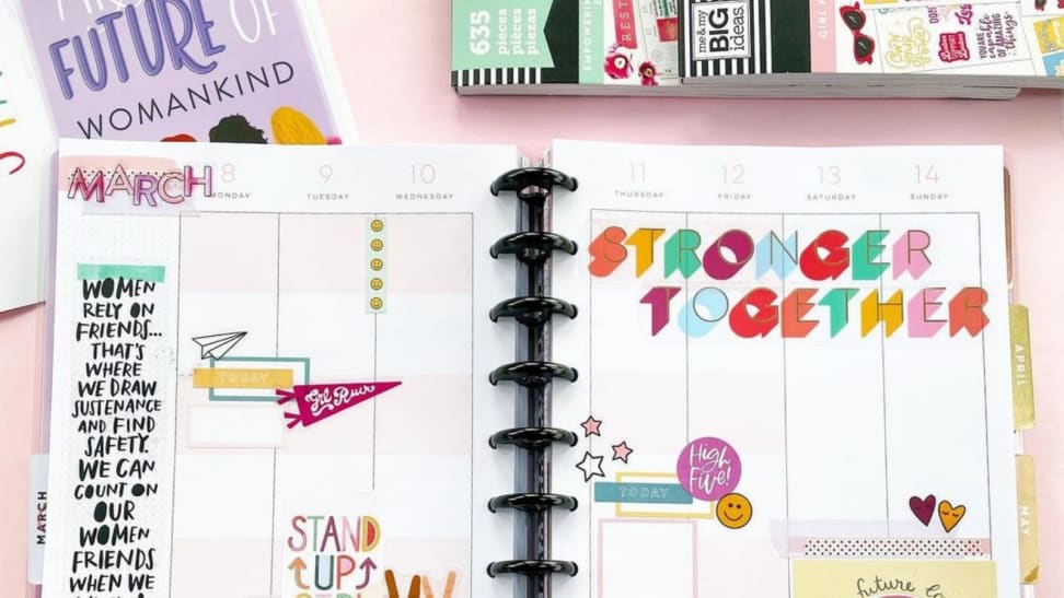 A colorful planner from Happy Planner with stickers.