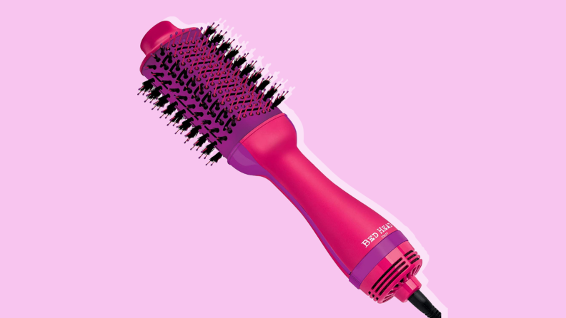 Bed Head hair brush in front of a purple background.