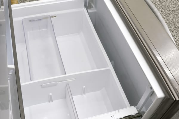 Just inside the freezer door is a Pizza Pocket, ideal for storing thin items that are tall or wide and might not fit well in the drawers.