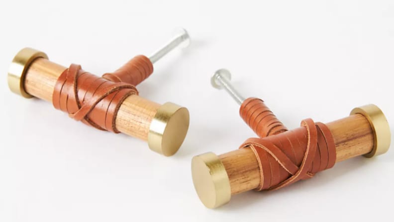 Two teakwood cabinet handles side by side