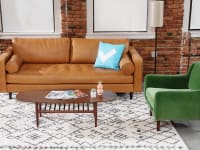 Common room space featuring the Article Sven Charme Leather Couch, Matrix Velvet Chair and Lenia Walnut Oval Coffee Table.