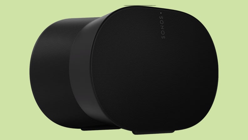 A black speaker sits on a green background