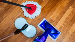 Three of the best mops we tested sit on a shiny hardwood floor