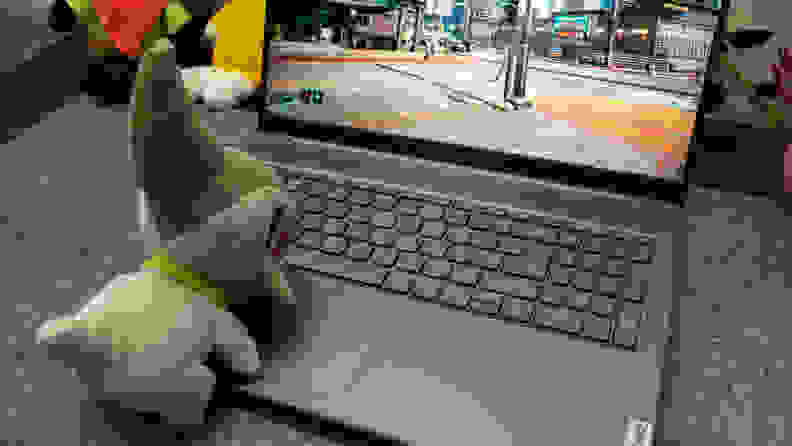 An open Lenovo Ideapad Gaming Chromebook with a stuffed animal on its keyboard, enjoying the fast Wi-Fi.