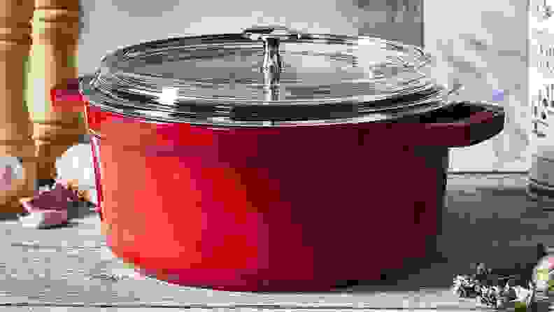 A red Staub cast iron cocette on a countertop.
