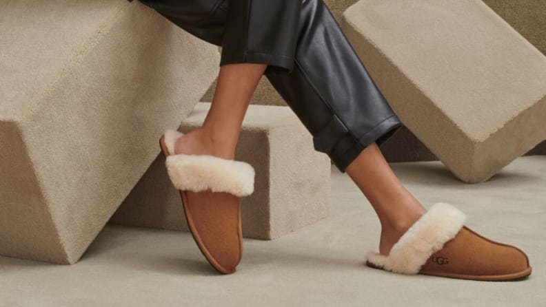 A woman wearing Ugg slippers.