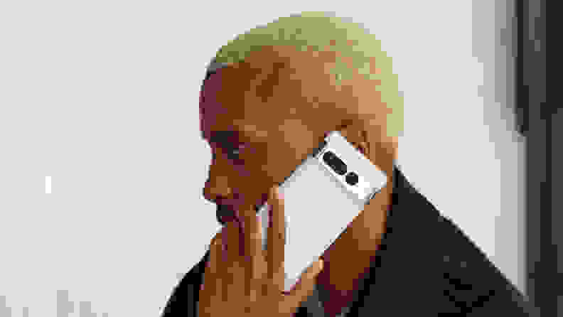 A man talking on a Google Pixel 7 Pro smart phone.