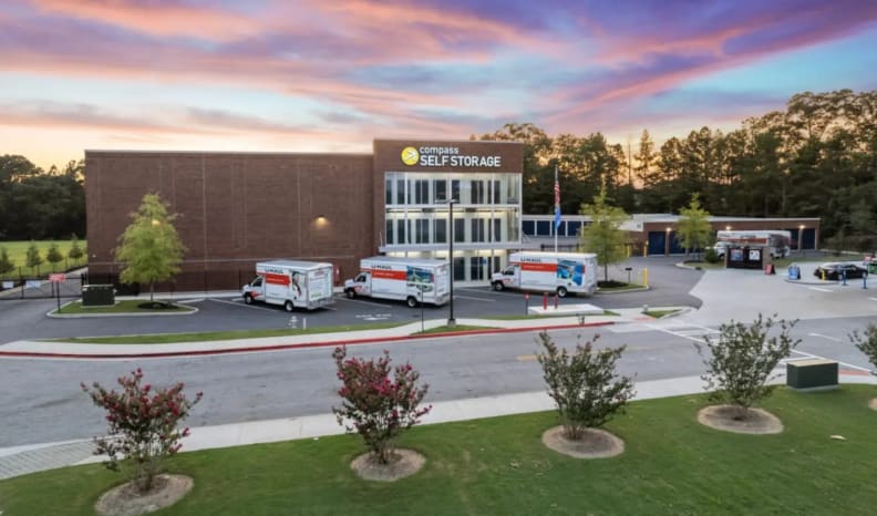 A large self-storage facility and hauling trucks parked out front