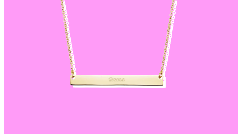 A Brilliant Earth Horizontal Bar Pendant on a pink background.