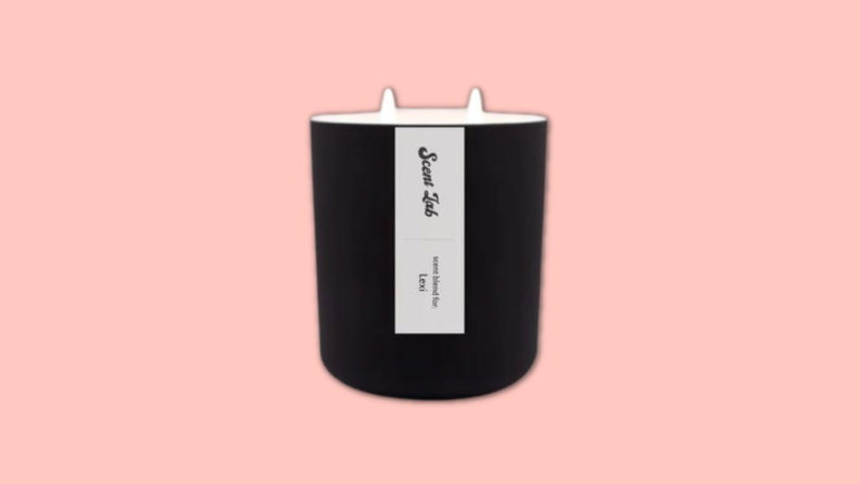 A Scent Lab candle against a pink background