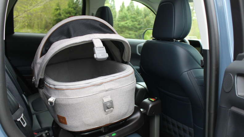The Tavo Maeve Pet Car Seat installed in the back seat of a car.