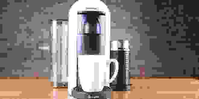 White coffee maker sitting on countertop.