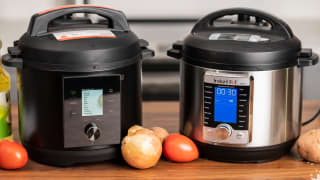 Two pressure cookers sitting side by side.