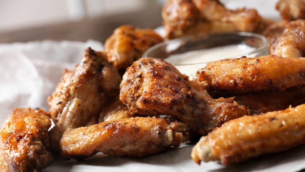 A closeup of nicely browned chicken wings on a plate.