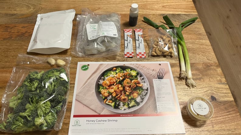 A Home Chef recipe card for a shrimp and rice bowl surrounded by its ingredients