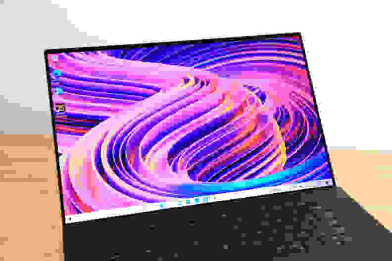 A laptop display turned on and showing off a colorful wallpaper