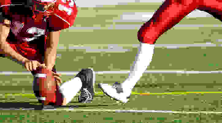 Player kicking football