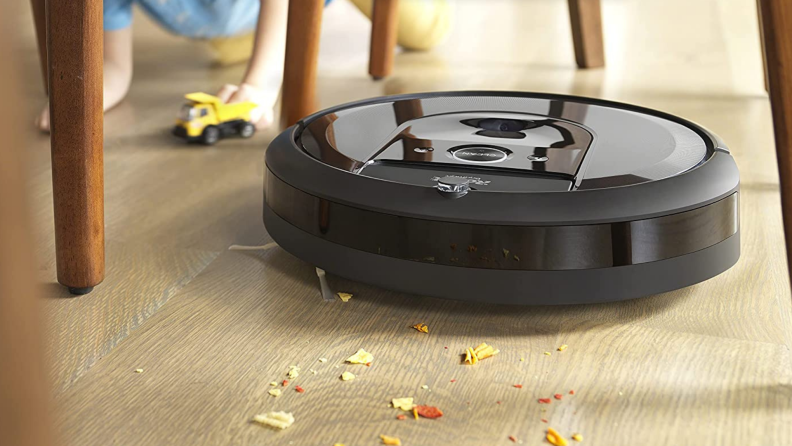 Roomba j7+ vacuuming under a table