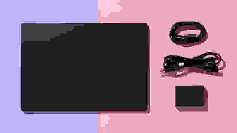 The LG gram Pro 17 laptop next to two USB cord and charging cube.