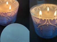 Bath & Body Works candle sitting on table.