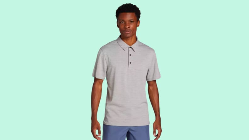 An image of a heathered, pale gray golf polo with short-sleeves.