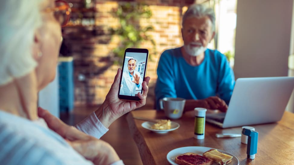 A senior couple consults with their doctor.