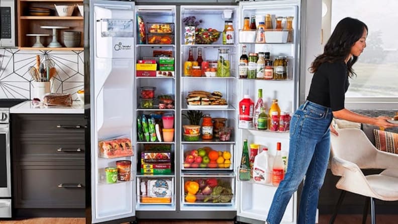 Image of person putting food into the fridge